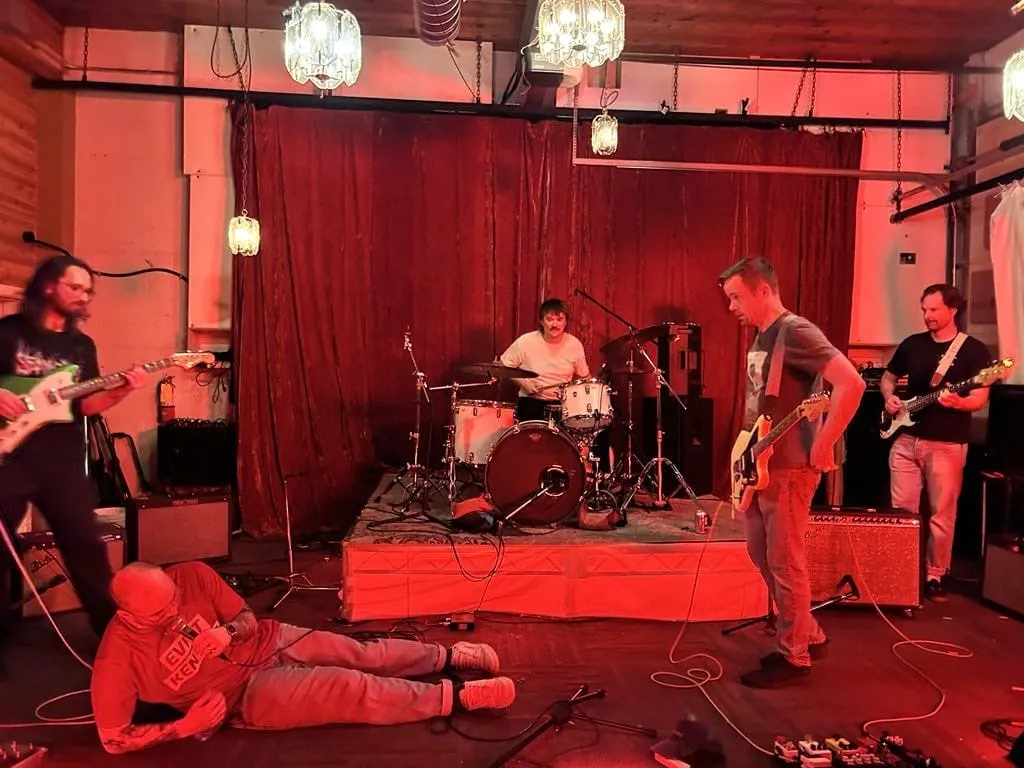 Priced Out playing live on stage.